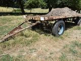 a trailer with a pile of hay on the back of it
