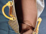 a brown and yellow bag that is open on a blue surface