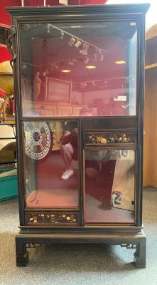 a display case with a clock inside of it