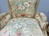 a chair with a floral upholstered cushion and a chair with a floral upholstered cushion
