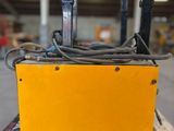 a yellow box sitting on top of a wooden pallet in a warehouse