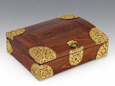 an ornate wooden box with gold decorations on it
