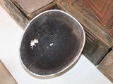 a black bowl sitting on top of a white table