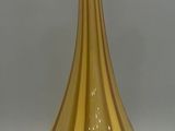 a glass vase sitting on a table with a gray background