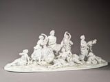 a white sculpture of a group of people on a boat