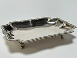 a silver tray with a handle on a white surface
