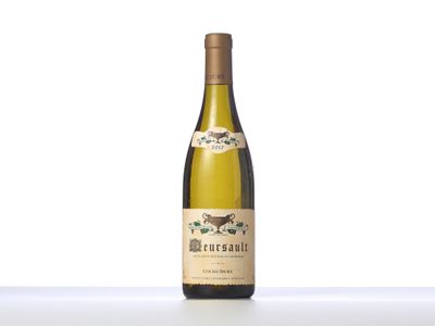 a bottle of white wine sitting on top of a table