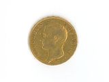 a close up of a gold coin on a white surface