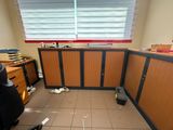 a picture of a room with a desk and a trash can