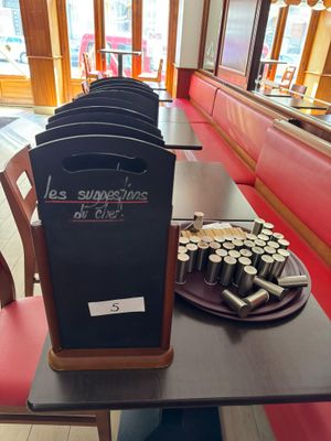 a blackboard sign on a table in a restaurant