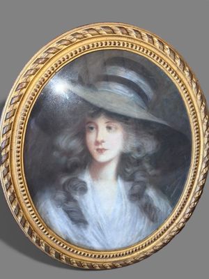 portrait of a lady in a hat by a gold frame