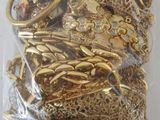 a bag of gold jewelry in it on a table