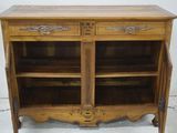 a wooden cabinet with two doors and a drawer