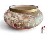 a vase that has a gold lid on it