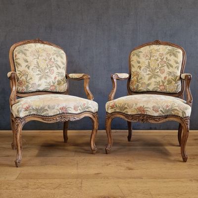 pair of louis xv style armchairs with floral upholstered upholstered cushions
