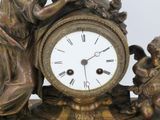 a statue of a woman holding a clock with angels around it