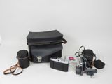 a camera, a camera case, a camera and other items on a white surface