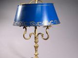 an image of a blue lamp with a gold base and a blue shade