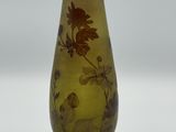 a yellow vase with a floral design on it