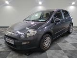 a picture of a small grey car parked in a garage