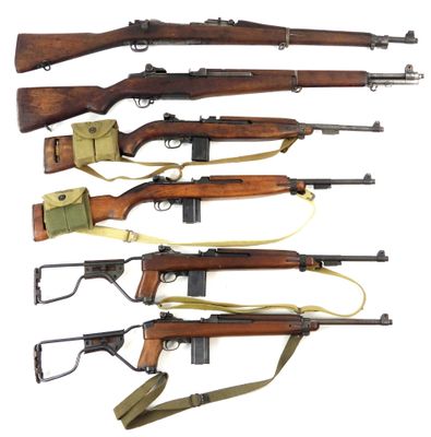 a group of six rifles with different types of wood and metal
