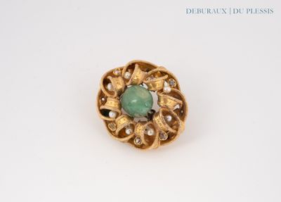 an image of a green stone and pearl broochle on a white surface