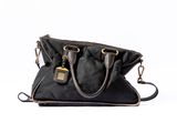 black handbag on a white background with a key in it