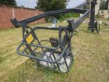 a small crane that is sitting in the grass
