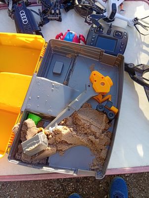 a box full of toys and tools on a table