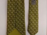 yellow and green neck tie with a blue label on it
