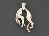 a silver pendant with a cat on it ' s back on a black surface