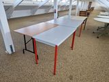 two tables that are sitting in the middle of a room
