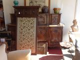 a room filled with furniture and a cat sitting on the floor