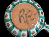 a green and white bowl with a picture of a horse on it