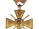 an image of a gold medal with a red, green and black ribbon