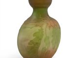 a glass vase with a green and yellow design on it
