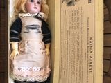 a doll that is in a box on the floor