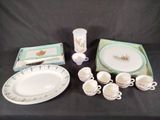 a table with a lot of dishes and cups and saucers