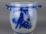 a blue and white vase with a bird on it