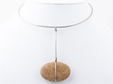 necklace with a wooden bead and a silver chain on a white mannequin