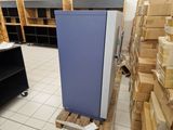 an image of a refrigerator in a warehouse with boxes on the floor