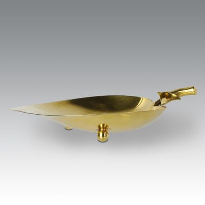 an image of a gold plate with a bird on it