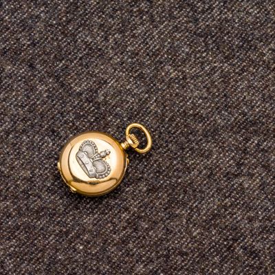 un gros plan d'une montre de poche avec une chaîne en or