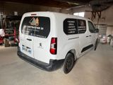 a van that is parked in a garage with other vehicles