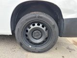 a white van with a flat tire parked on the side of the road