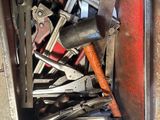 a metal box filled with various tools on the floor