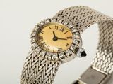 a close up of a wrist watch with roman numerals on it