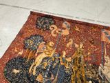 a cat that is sitting on a rug on the floor