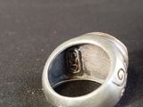 a silver ring with a skull in it on a table