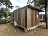 a small wooden cabin sitting in the middle of a field